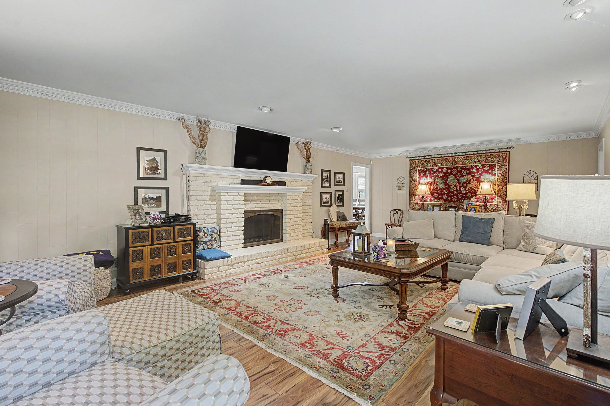 1929 Miller Farms Road Germantown, TN 38138 - Photo 10 of 40 Spacious living area featuring light wood-finish flooring and a white brick fireplace