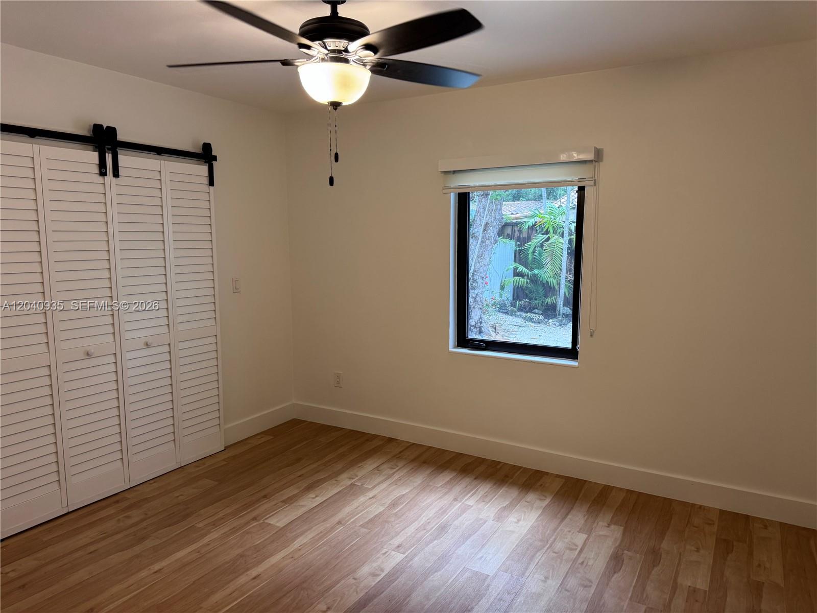 375 Southwest 32nd Road Miami, FL 33129 - Photo 39 of 44 a view of an empty room with wooden floor and a window