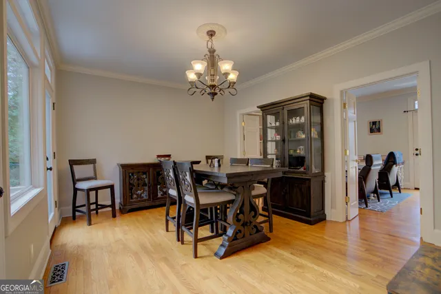 a view of a dining room with furniture and wooden floor
