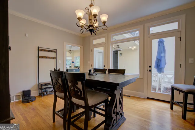 a view of a dining room with furniture and chandelier