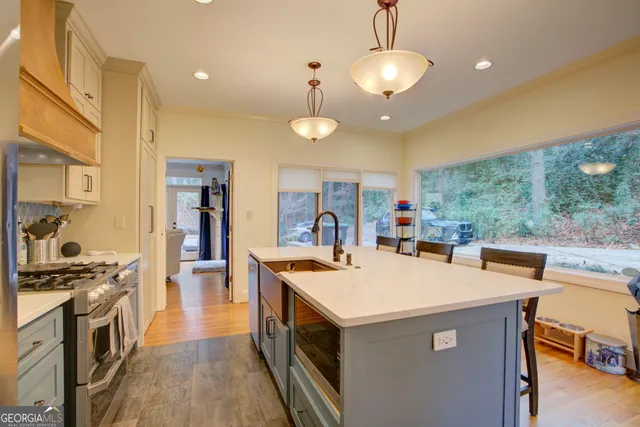a kitchen that has a lot of cabinets in it and stainless steel appliances