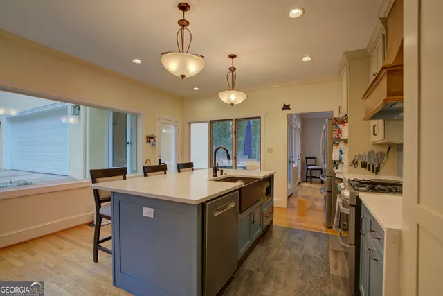 a kitchen with stainless steel appliances a sink stove and refrigerator