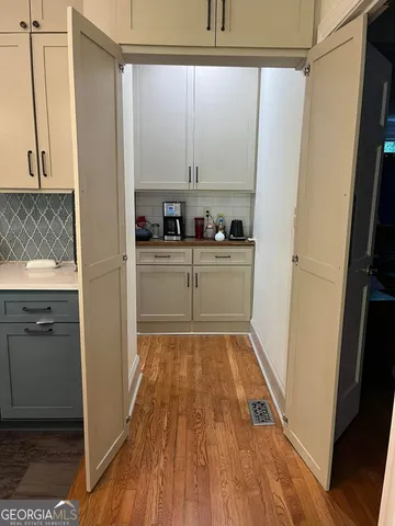 a kitchen with white cabinets and white appliances