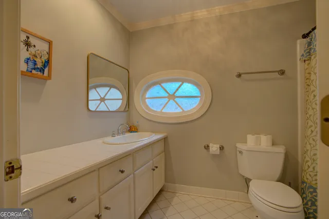 a bathroom with a toilet a sink and a mirror