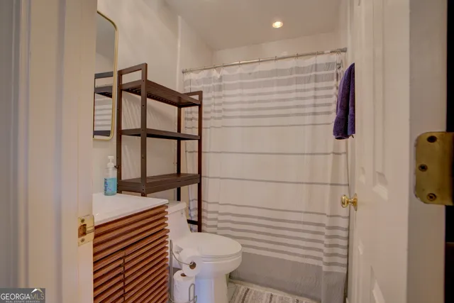 a bathroom with a shower and a sink