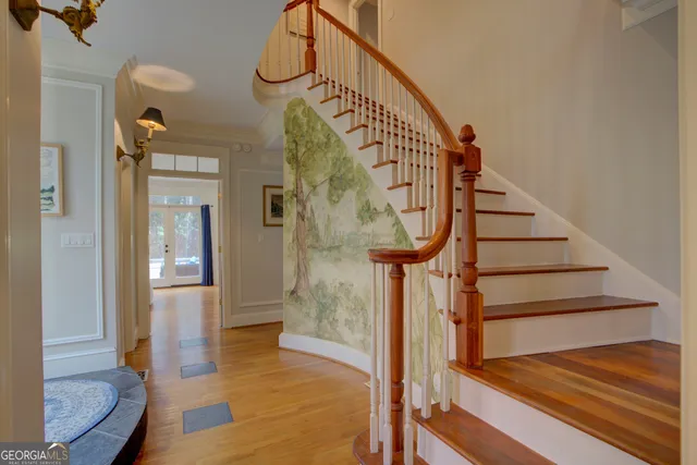 a view of entryway and hall with wooden floor