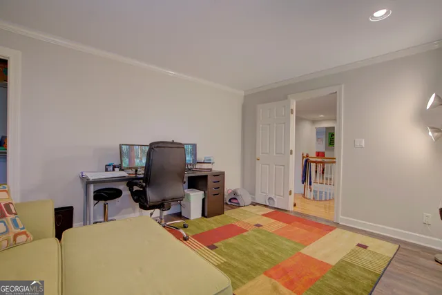 a bedroom with a bed and a desk