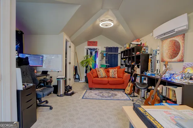 a living room with furniture a rug and a closet