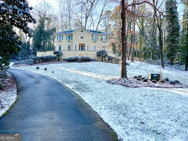 a view of a house with a yard and tree