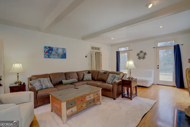 a living room with furniture and wooden floor