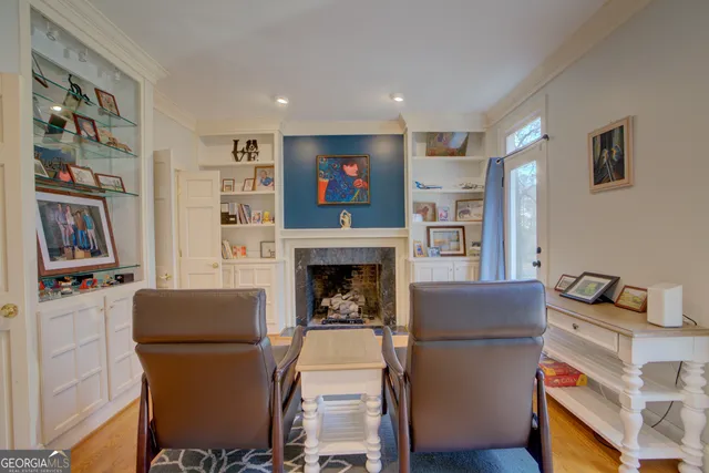 a living room with furniture a flat screen tv and a fireplace