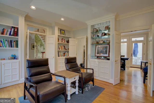 a living room with furniture and a book shelf
