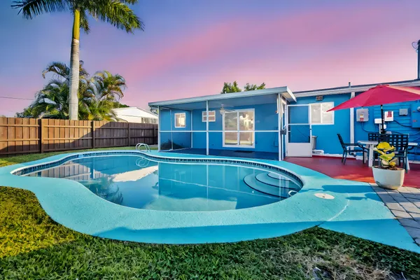 a view of a house with swimming pool and porch