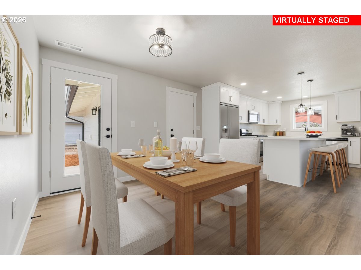 795 Northwest 6th Avenue Canby, OR 97013 - Photo 19 of 40 a kitchen with a dining table chairs and refrigerator