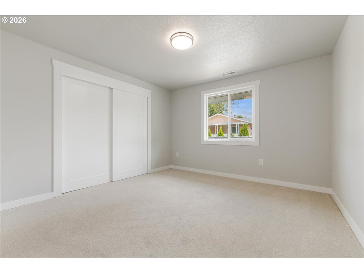 795 Northwest 6th Avenue Canby, OR 97013 - Photo 23 of 40 an empty room with windows and closet