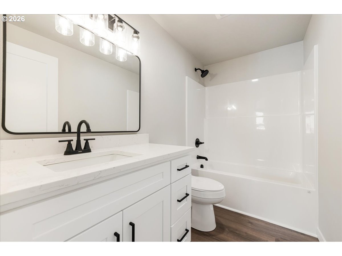 795 Northwest 6th Avenue Canby, OR 97013 - Photo 30 of 40 a bathroom with a sink a toilet and a mirror
