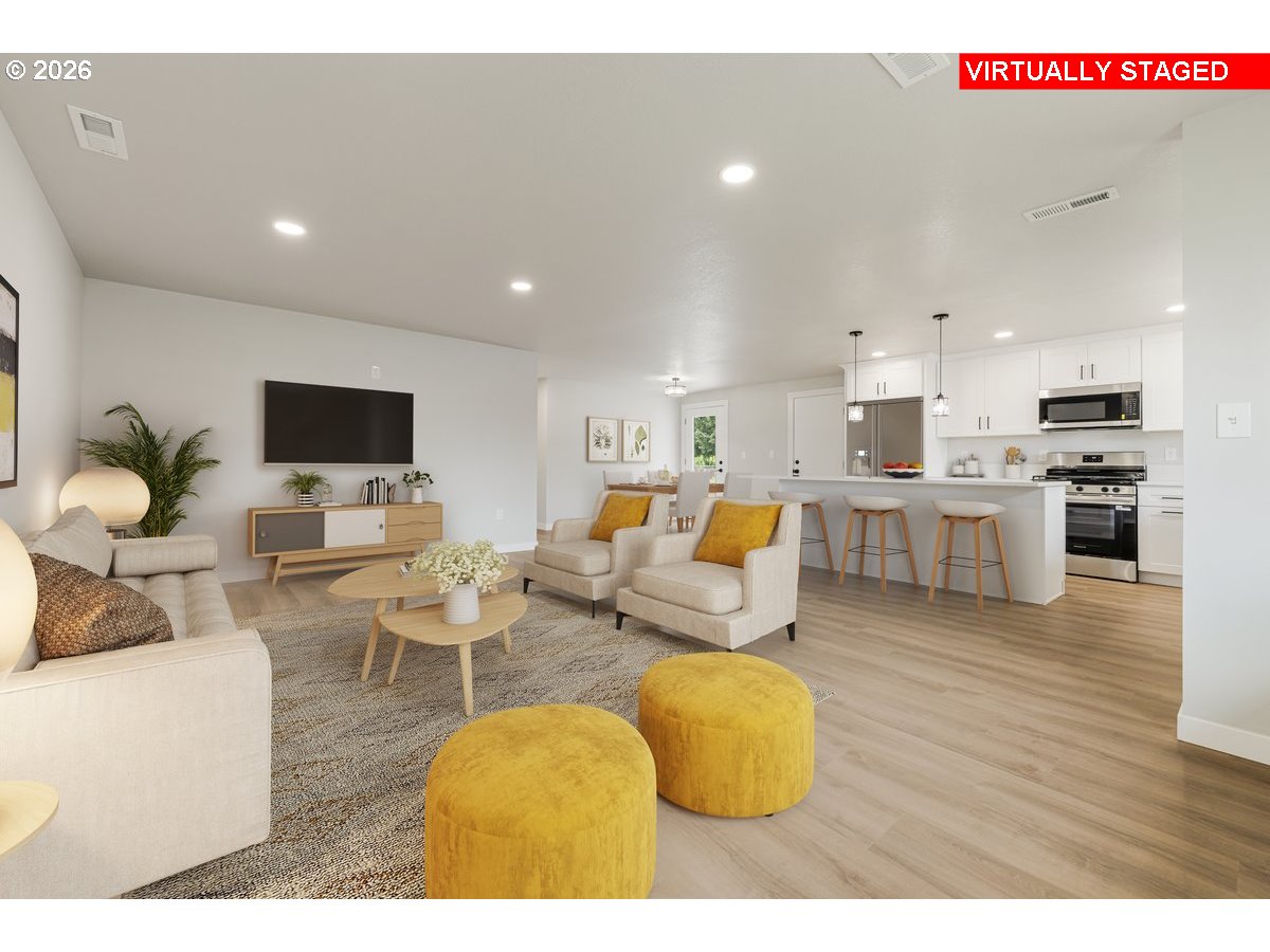 795 Northwest 6th Avenue Canby, OR 97013 - Photo 9 of 40 a living room with furniture and a flat screen tv