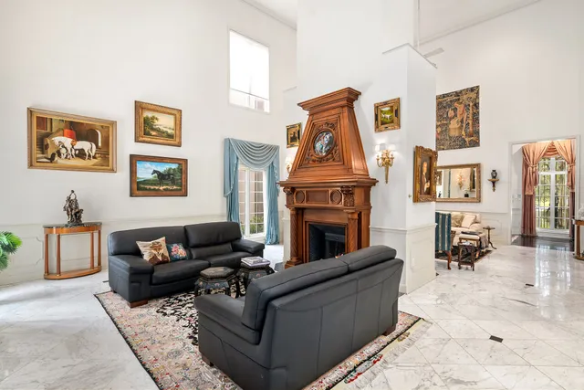 a living room with furniture a rug and a fireplace