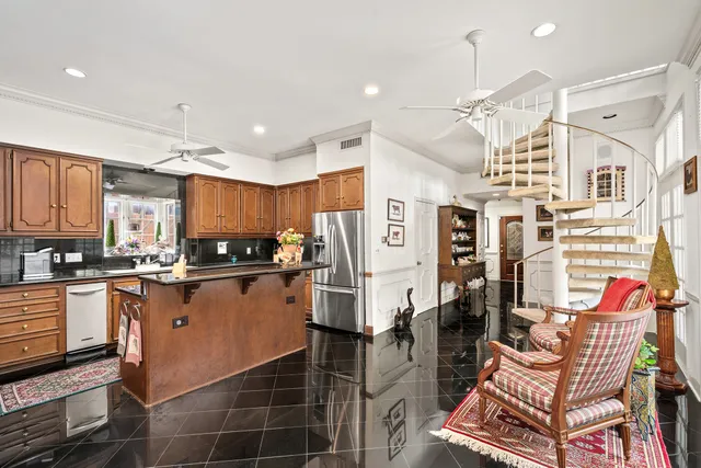 a kitchen with stainless steel appliances kitchen island granite countertop a refrigerator and microwave