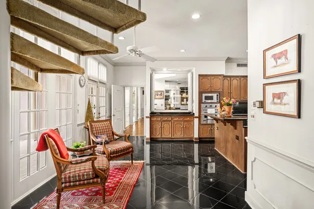 a living room with furniture a flat screen tv and next to a window