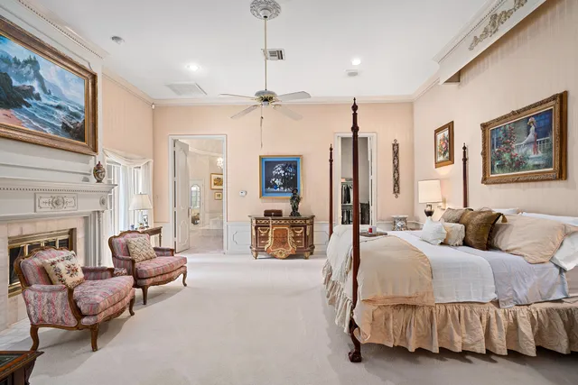 a spacious bedroom with a bed couch and a fireplace