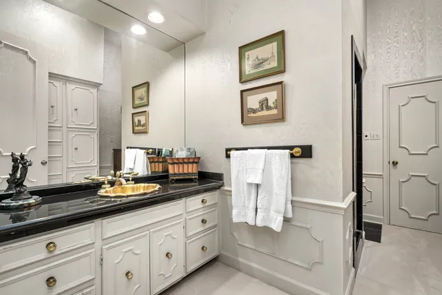 a bathroom with a double vanity sink a mirror and a bathtub