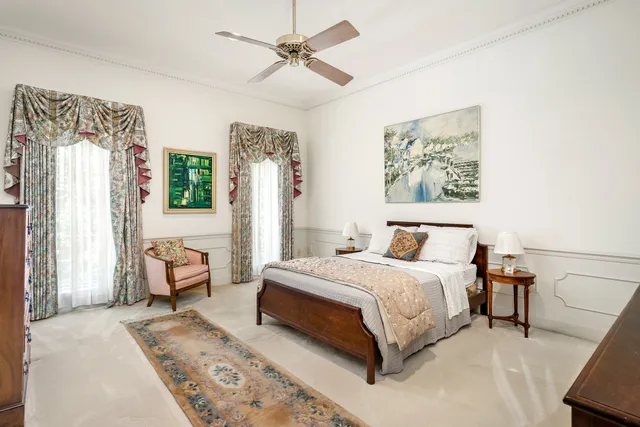 a spacious bedroom with a bed a couch and a window