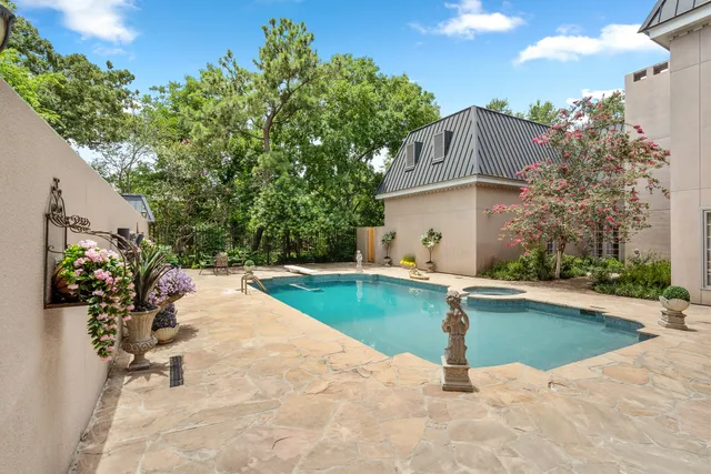 a swimming pool with outdoor seating and yard