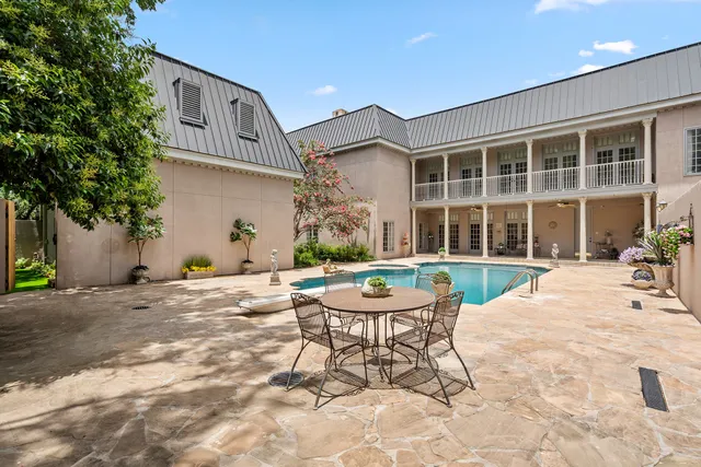 a view of a house with backyard porch and sitting area