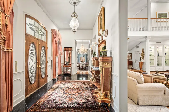 a view of living room filled with furniture and large windows