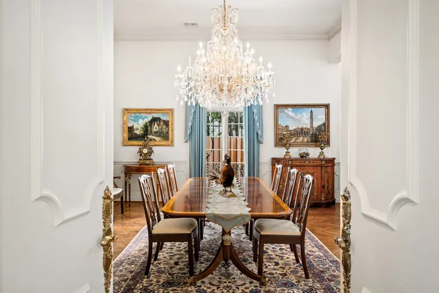 a view of a dining room with furniture and chandelier