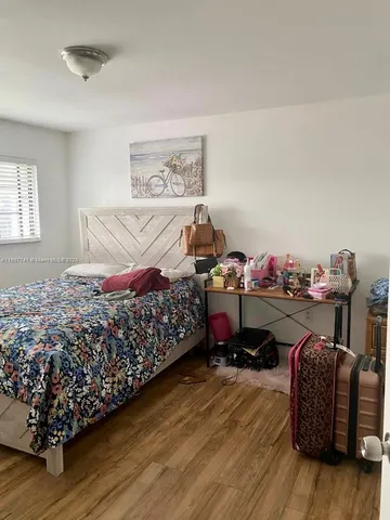 a bedroom with bed and a dresser