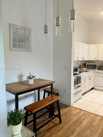 a kitchen with a table and chairs