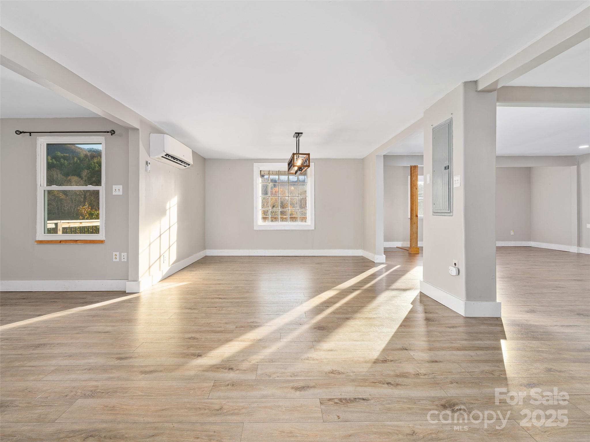 3477 Cane Creek Road Bakersville, NC 28705 - Photo 11 of 30 a view of a big room with wooden floor and windows