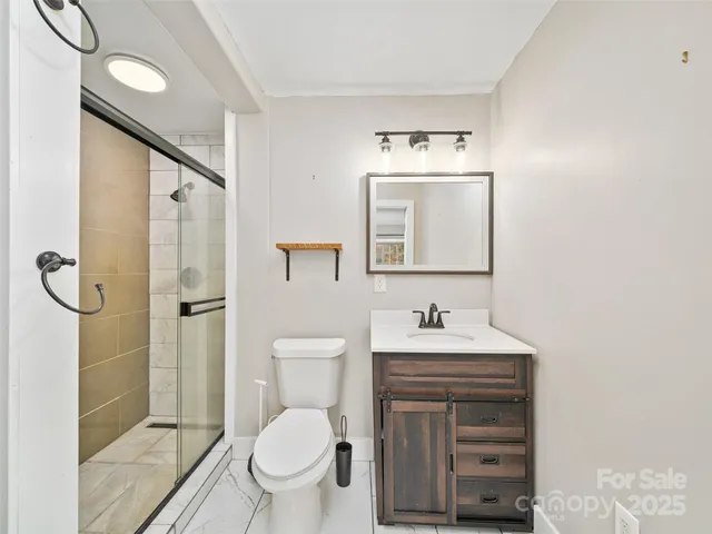 a bathroom with a sink toilet and shower