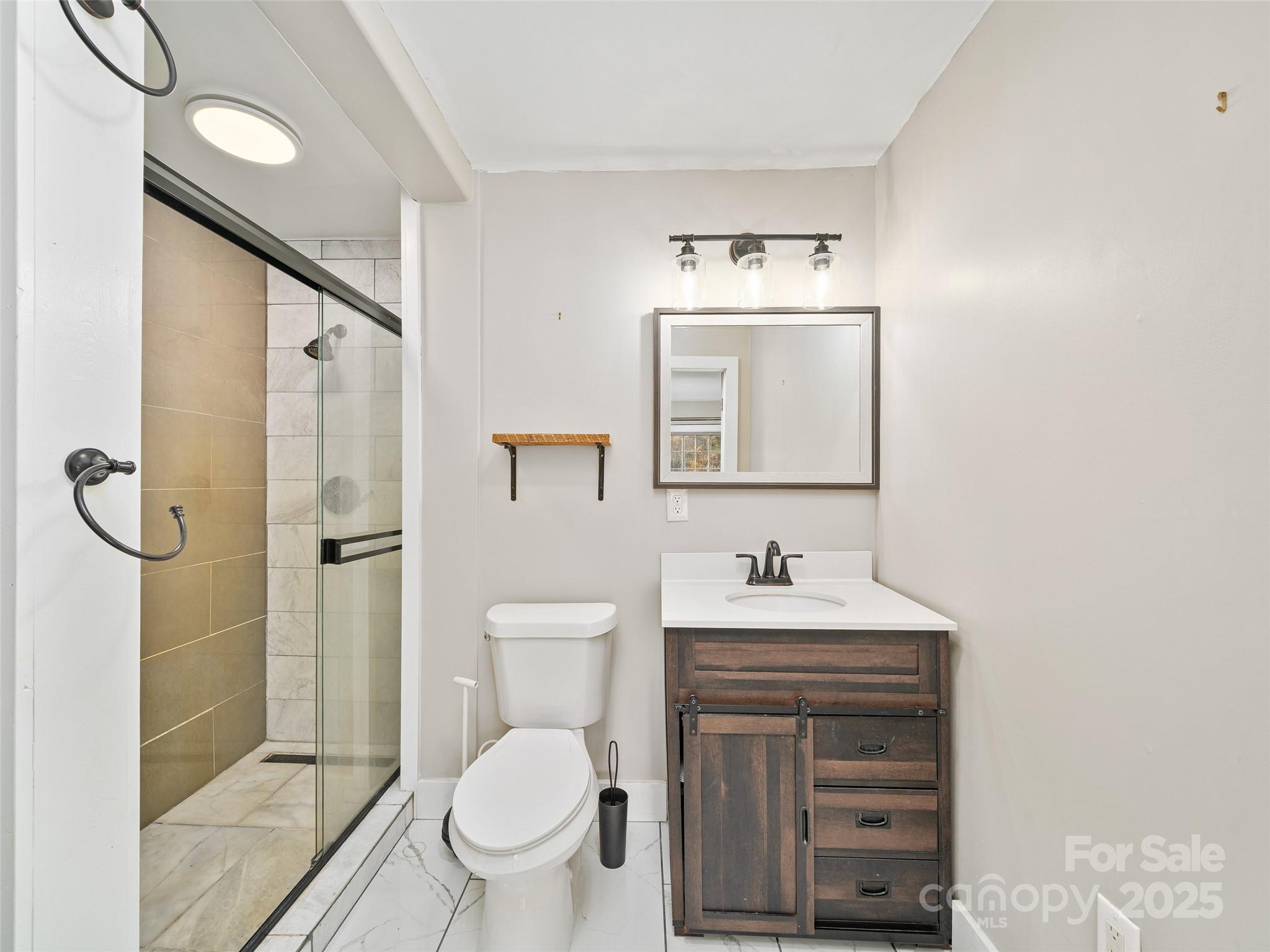 3477 Cane Creek Road Bakersville, NC 28705 - Photo 17 of 30 a bathroom with a sink toilet and shower