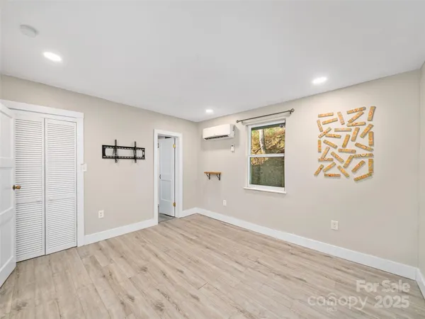 an empty room with windows and closet