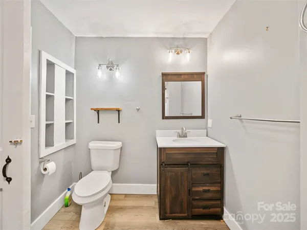 a bathroom with a toilet a sink and a mirror
