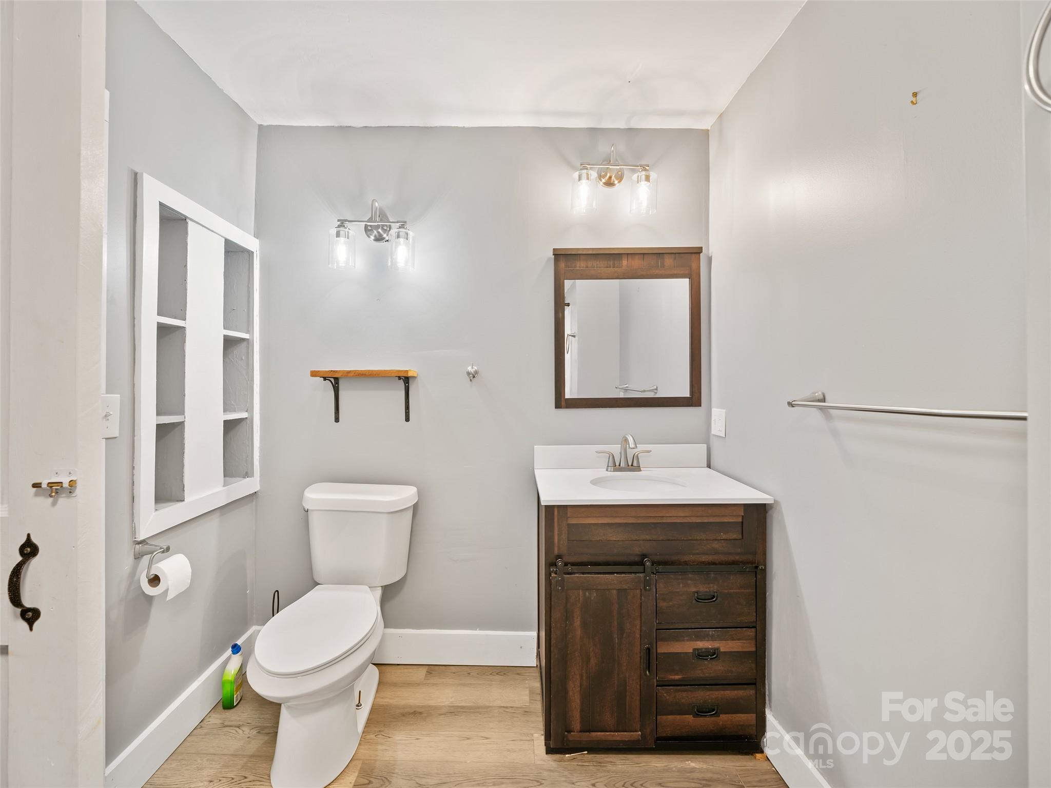 3477 Cane Creek Road Bakersville, NC 28705 - Photo 21 of 30 a bathroom with a toilet a sink and a mirror