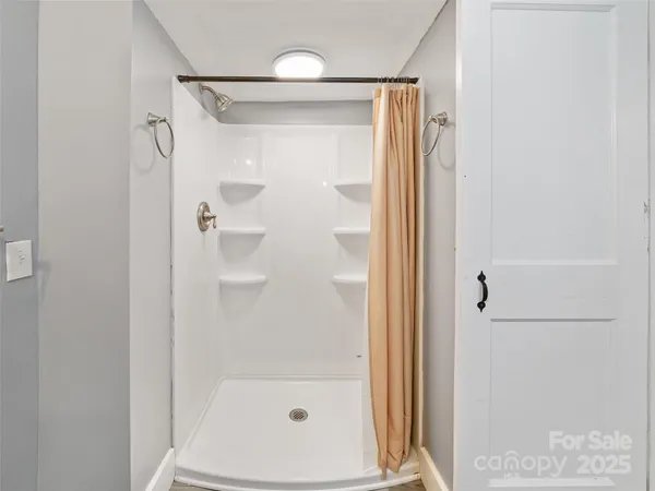 a bathroom with a glass shower door