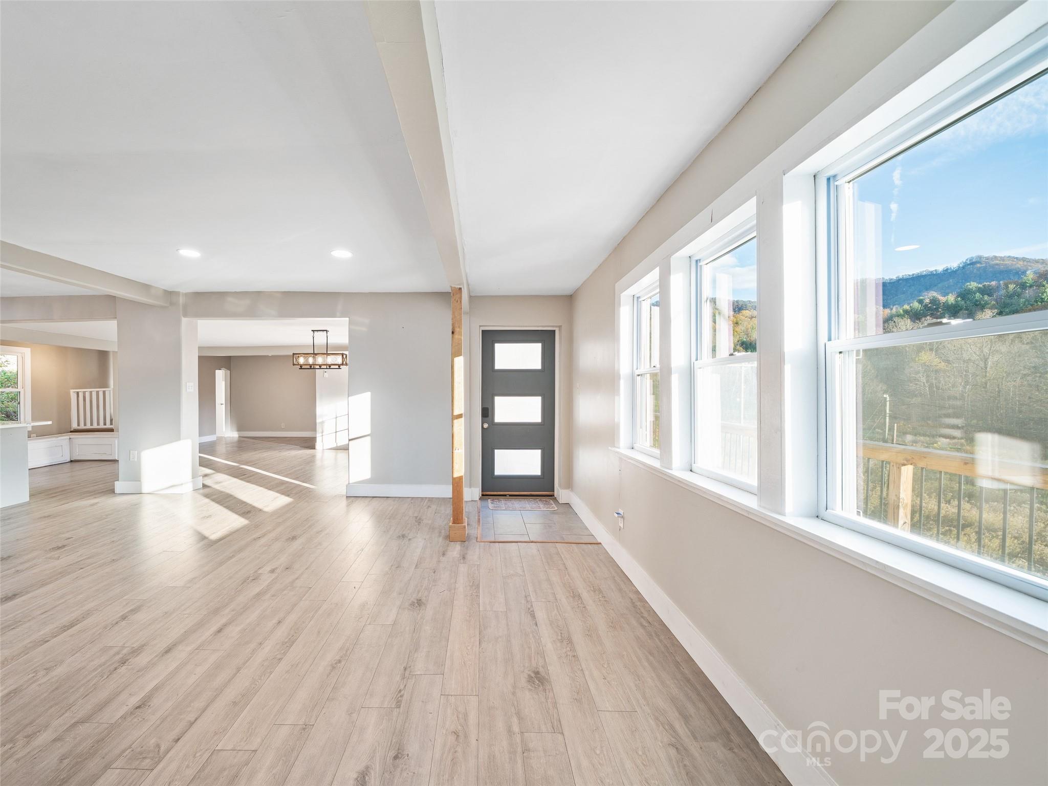 3477 Cane Creek Road Bakersville, NC 28705 - Photo 5 of 30 a view of an empty room with wooden floor and a window