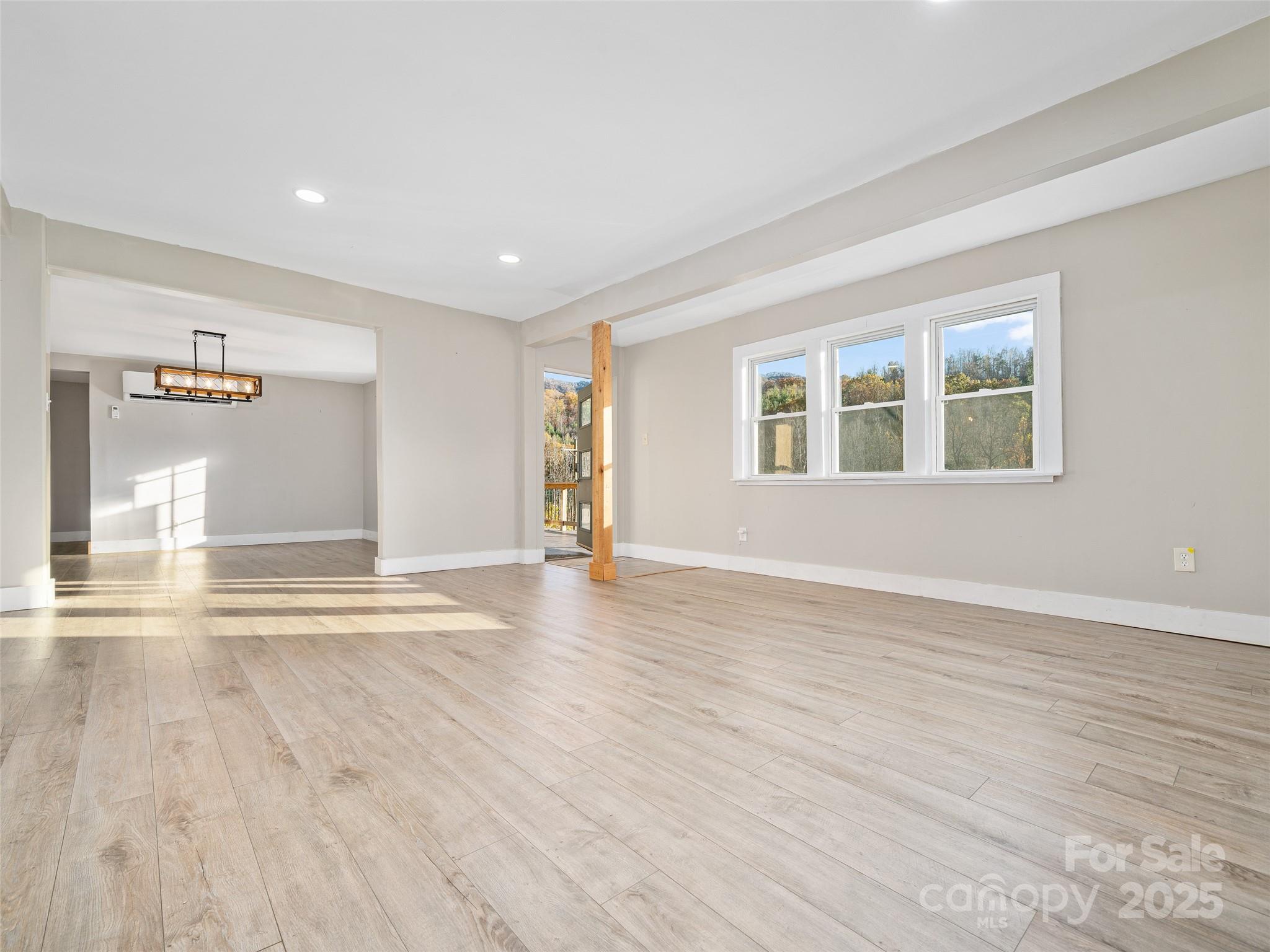 3477 Cane Creek Road Bakersville, NC 28705 - Photo 6 of 30 a view of a livingroom with wooden floor and a window