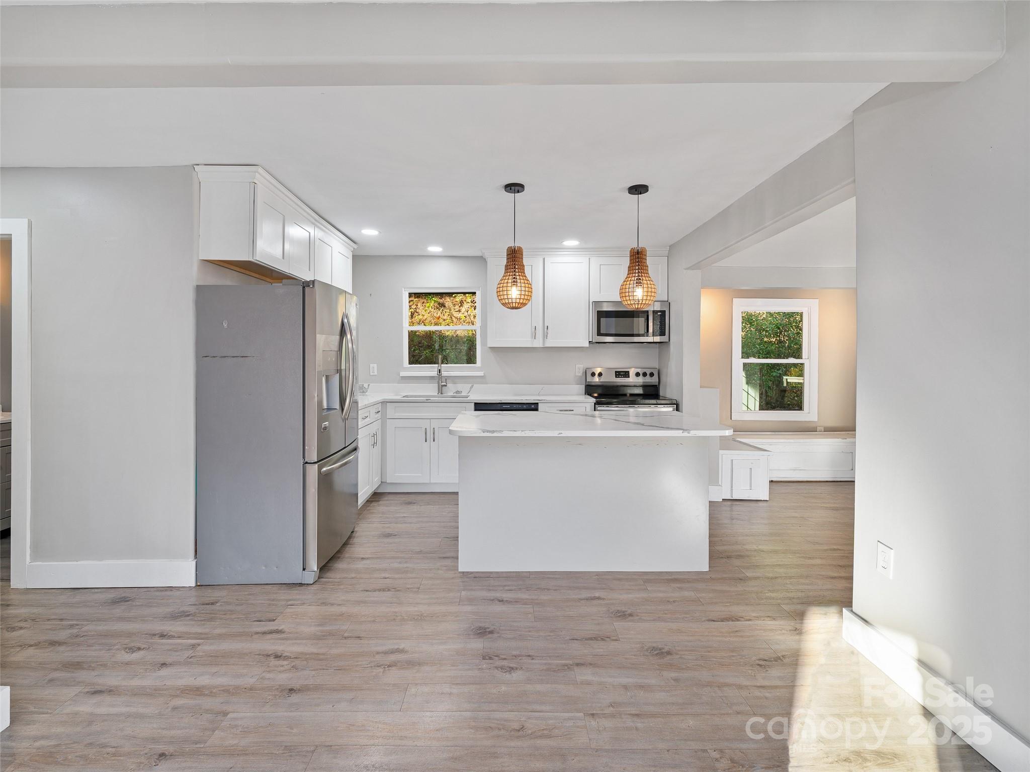 3477 Cane Creek Road Bakersville, NC 28705 - Photo 8 of 30 a kitchen with stainless steel appliances a refrigerator sink and cabinets