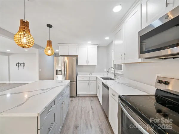 a kitchen with a sink appliances and cabinets