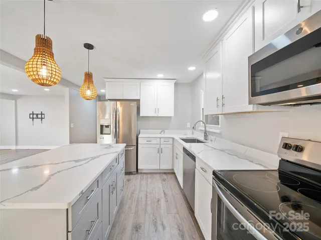 a kitchen with a sink appliances and cabinets