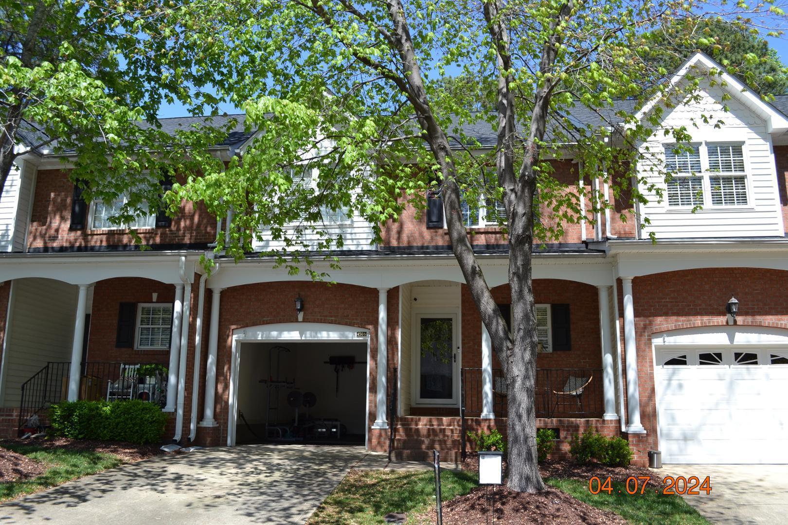 front view of a house with a tree