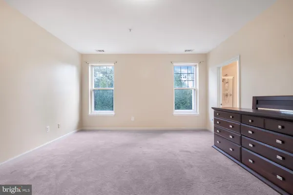 a living room with lots of furniture and a painting on the wall