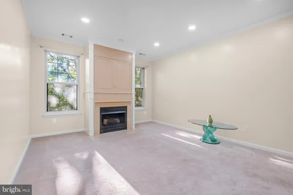 a view of a livingroom with a fireplace and window