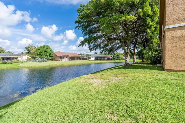 an aerial view of multiple houses with yard