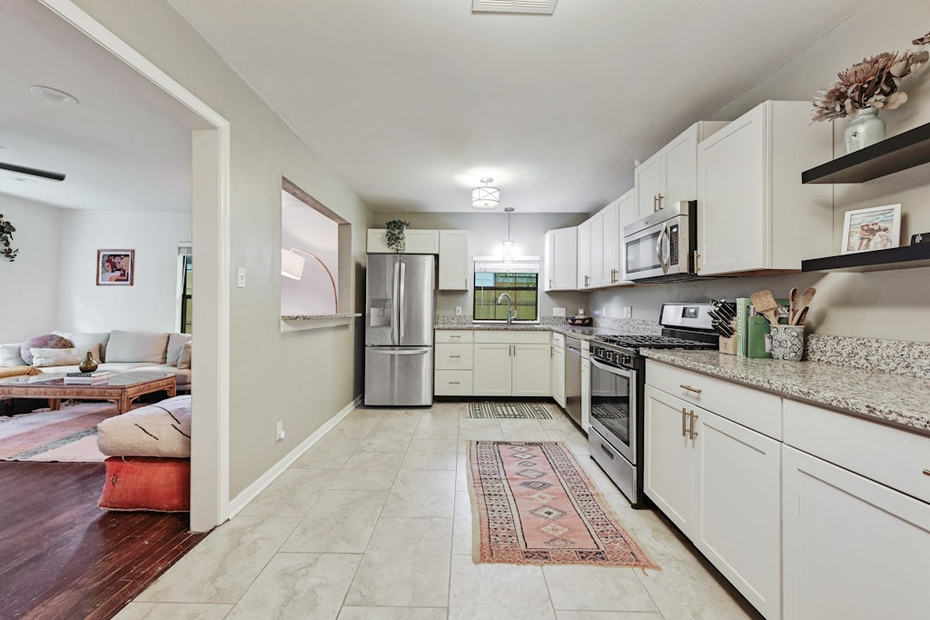 4025 Valley View Road, Unit 2 Austin, TX 78704 - Photo 9 of 19 a kitchen with stainless steel appliances granite countertop a refrigerator sink and cabinets